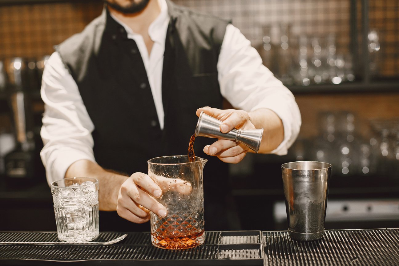 Bartender Pouring Alcoholic Drink to Glass